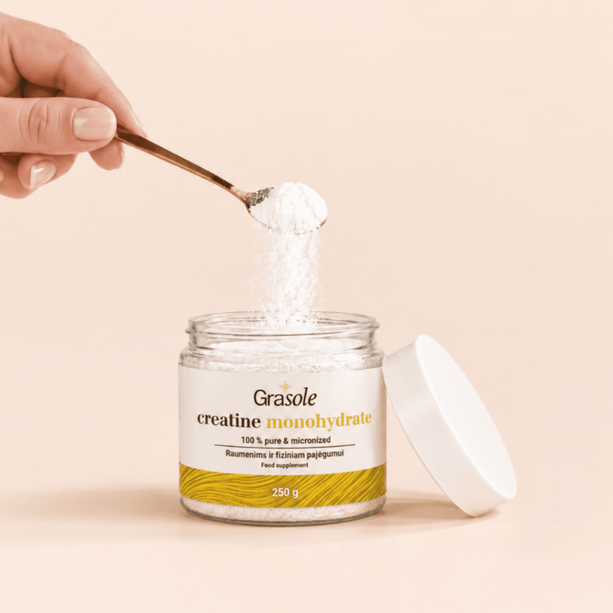 GraSole Creatine Monohydrate powder being scooped with a spoon